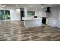 Spacious open-concept living area featuring hardwood floors and seamlessly connecting to the modern kitchen at 1130 W Lake Brantley Rd, Altamonte Springs, FL 32714