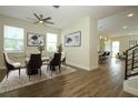 Bright dining room with wood floors, stylish furniture, a modern ceiling fan, and beautiful decor at 1222 Castlevecchio Loop, Orlando, FL 32825