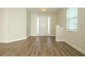 Spacious foyer with natural light, wood flooring, and a view of the front door and window at 1222 Castlevecchio Loop, Orlando, FL 32825