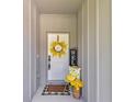 Cozy front porch with welcoming decor, a yellow wreath, and comfortable seating at 12260 Sw 56 Ln, Ocala, FL 34481