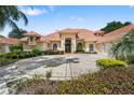 Gorgeous exterior highlighting the terracotta roof, elegant entry, and circular driveway at 1274 Prince Ct, Lake Mary, FL 32746