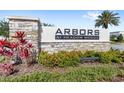 Arbors at Meadow Woods community sign made of stone with manicured landscaping around it at 15577 Willow Arbor Cir, Orlando, FL 32824