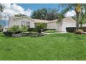 Charming home with well-kept lawn, landscaped yard, and inviting curb appeal at 17097 Se 96Th Chapelwood Cir, The Villages, FL 32162