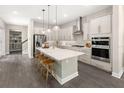 Stunning eat-in kitchen with a large center island, stainless steel appliances, and stylish pendant lighting at 1969 Beach Ter, Celebration, FL 34747