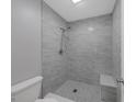 Modern bathroom with a stand up shower featuring gray tile and a pebble floor at 2206 Stonington Ave # 2206, Orlando, FL 32817