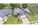 A high angle view of the house with lush green lawn and landscaped front yard at 2216 Grand Tree Ct, Lake Mary, FL 32746
