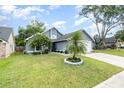 View of home showcasing front lawn, driveway, and attached two-car garage at 2216 Grand Tree Ct, Lake Mary, FL 32746