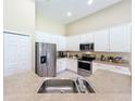 Bright kitchen with stainless steel appliances, white cabinets, and ample counter space at 2274 Foliage Oak Ter, Oviedo, FL 32766