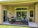 Outdoor patio with seating area, ceiling fans, and a view of the lush backyard at 2274 Foliage Oak Ter, Oviedo, FL 32766