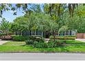 Beautiful home featuring a lush, green front yard with mature trees and manicured landscaping at 2312 S Summerlin Ave, Orlando, FL 32806