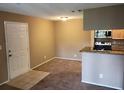 Inviting living area featuring neutral paint, plush carpeting, and an open layout to the kitchen at 236 Afton Sq # 207, Altamonte Springs, FL 32714