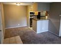 Inviting living area featuring neutral paint, plush carpeting, and an open layout to the kitchen at 236 Afton Sq # 207, Altamonte Springs, FL 32714