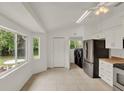 Bright kitchen with stainless steel appliances, tiled floor, and an adjacent laundry area, offering modern convenience at 295 Maguire St, Deltona, FL 32725