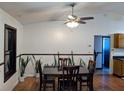The dining room has a wooden table, chairs and hardwood floors with a view into the kitchen at 3021 Norvell Ct, Deltona, FL 32738