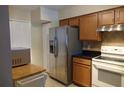 The kitchen features wood cabinets, stainless steel appliances, and a granite counter at 3024 S Semoran Blvd # 7, Orlando, FL 32822
