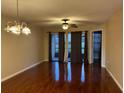 Living room boasting wood floors, a ceiling fan and sliding glass doors at 3024 S Semoran Blvd # 7, Orlando, FL 32822