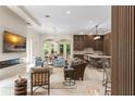 Open-concept living room with a modern fireplace, natural light, and seamless connection to the kitchen at 3426 Cocard Ct, Windermere, FL 34786
