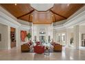 Spacious living room features a wood-paneled ceiling and soaring windows, offering a bright and inviting atmosphere at 3426 Cocard Ct, Windermere, FL 34786