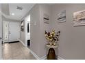 Bright foyer featuring neutral tones, tile flooring, and decorative wall art at 3508 Porta Romano Way, Lake Mary, FL 32746