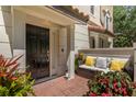 Inviting front porch with a comfortable sitting area, plants, and a decorative lighthouse at 3508 Porta Romano Way, Lake Mary, FL 32746