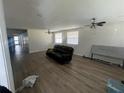Spacious living room features wood flooring, ceiling fans, and lots of natural light from two windows at 4204 Columbia St, Orlando, FL 32811