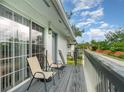 Balcony view features wood decking, gray railings, and outdoor seating perfect for relaxing at 4890 Conway Rd # 66, Orlando, FL 32812
