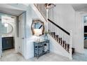 Inviting foyer with a staircase, stylish mirror, and elegant console table at 503 Savona Ct, Altamonte Springs, FL 32701