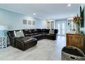 Comfortable living room with tile flooring, recessed lighting, and a large leather sectional at 503 Savona Ct, Altamonte Springs, FL 32701