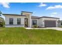 A charming single-story home with a well-maintained lawn and a gray two-car garage at 6421 Sw 151St Loop, Ocala, FL 34473