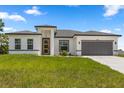 A charming single-story home with a well-maintained lawn and a gray two-car garage at 6421 Sw 151St Loop, Ocala, FL 34473