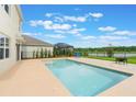 Backyard pool area offering serene water views and ample space for outdoor relaxation and entertainment at 6808 Cranes Roost Rd, Harmony, FL 34773