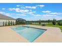 Backyard pool area offering serene water views and ample space for outdoor relaxation and entertainment at 6808 Cranes Roost Rd, Harmony, FL 34773