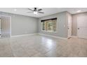 Bright living room featuring neutral walls, large windows and tile floors, offering a versatile space at 811 Osceola Trl, Casselberry, FL 32707