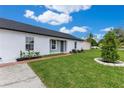 Landscaped front yard with brick path leading to a well-maintained home at 8111 Lianna Dr, Orlando, FL 32822