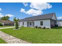 Well-kept front yard with lush lawn and white painted brick exterior at 8111 Lianna Dr, Orlando, FL 32822