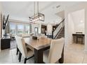 Open-concept dining area with stylish lighting, seamlessly connected to the kitchen and living spaces at 8955 Fluffy Lie Ct, Davenport, FL 33896