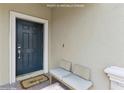 Inviting front door with Welcome mat and a comfortable bench for guests at 8955 Fluffy Lie Ct, Davenport, FL 33896