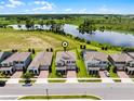 Desirable two-story home with beautiful pond views, manicured landscaping, and a paved driveway at 9128 Sonoma Coast Dr, Winter Garden, FL 34787