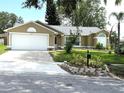 Charming one-story home with a white garage door, a well-maintained lawn, and front yard landscaping at 926 Freshmeadow Ct, Apopka, FL 32703