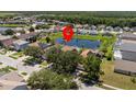 Overhead view of a residential neighborhood showcasing the home's position on a beautiful pond at 1111 Liberty Hall Dr, Kissimmee, FL 34746