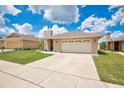 Well-maintained home with a spacious driveway, a two-car garage, and green lawn at 1166 Mapimi Ct, Winter Springs, FL 32708