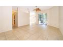 Spacious living room with tile flooring and a sliding glass door leading to the outdoor patio at 1173 Valley Creek Run, Winter Park, FL 32792
