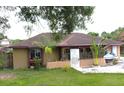 Charming one-story home with a well-manicured lawn and a welcoming entrance at 12207 Florida Woods Ln, Orlando, FL 32824