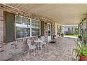 Inviting brick front porch with seating and decorative plants at 14157 Louisville Ct, Orlando, FL 32826