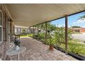 Covered front porch with brick flooring and comfortable outdoor seating at 14157 Louisville Ct, Orlando, FL 32826