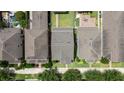 Overhead view of the home with a well-maintained roof, green lawn, and proximity to the street at 15448 Murcott Blossom Blvd, Winter Garden, FL 34787
