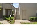 Exterior view showing a stairway to the upper levels and back access door at 165 Durham Pl # 165, Longwood, FL 32779