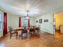 Elegant dining room with hardwood floors, a chandelier, and ample natural light at 1850 Lakeshore Cir, Longwood, FL 32750