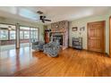 Inviting living room features a brick fireplace, wood floors, and comfortable seating at 1850 Lakeshore Cir, Longwood, FL 32750