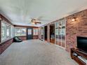 Bright sunroom with brick walls, carpet, and many windows at 1850 Lakeshore Cir, Longwood, FL 32750